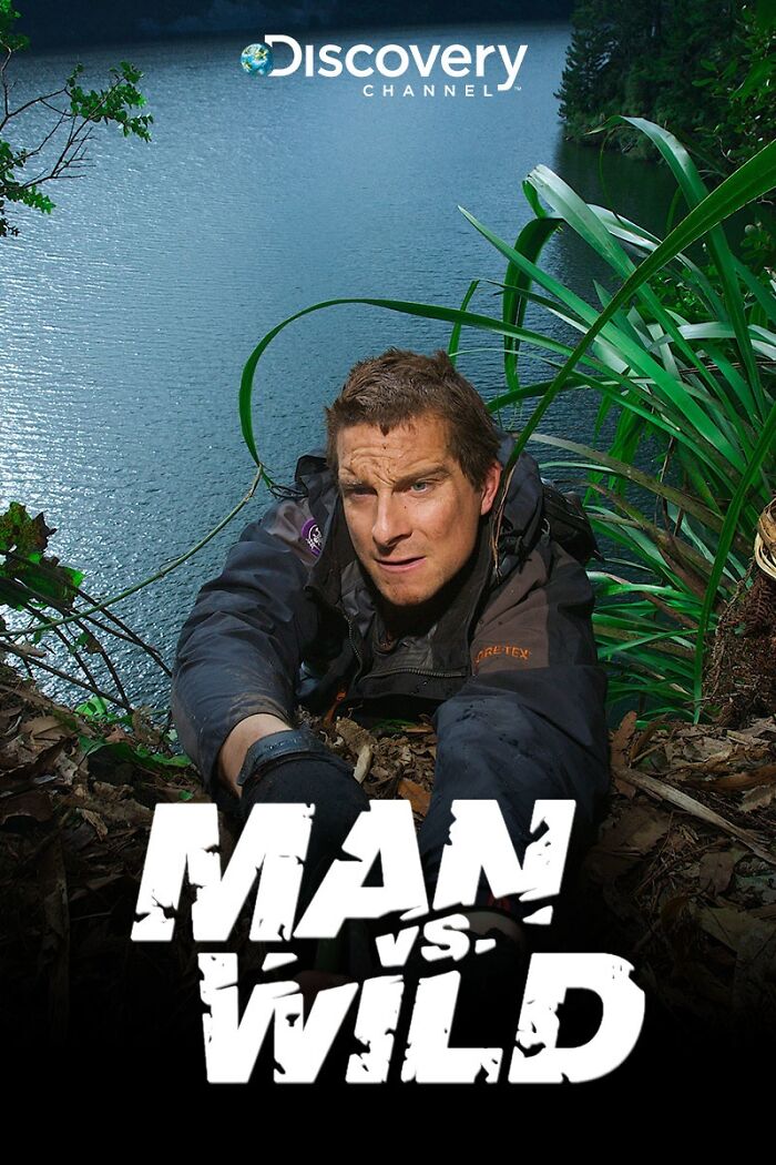 "Man vs. Wild host climbing a cliff, showcasing survival tactics in a rugged outdoor setting, aired on Discovery Channel."