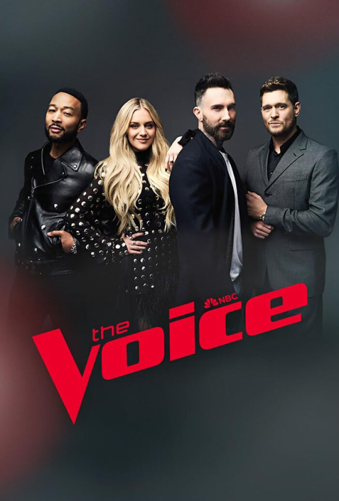 Four judges from "The Voice" standing together, dressed in formal attire, in front of the show's logo.