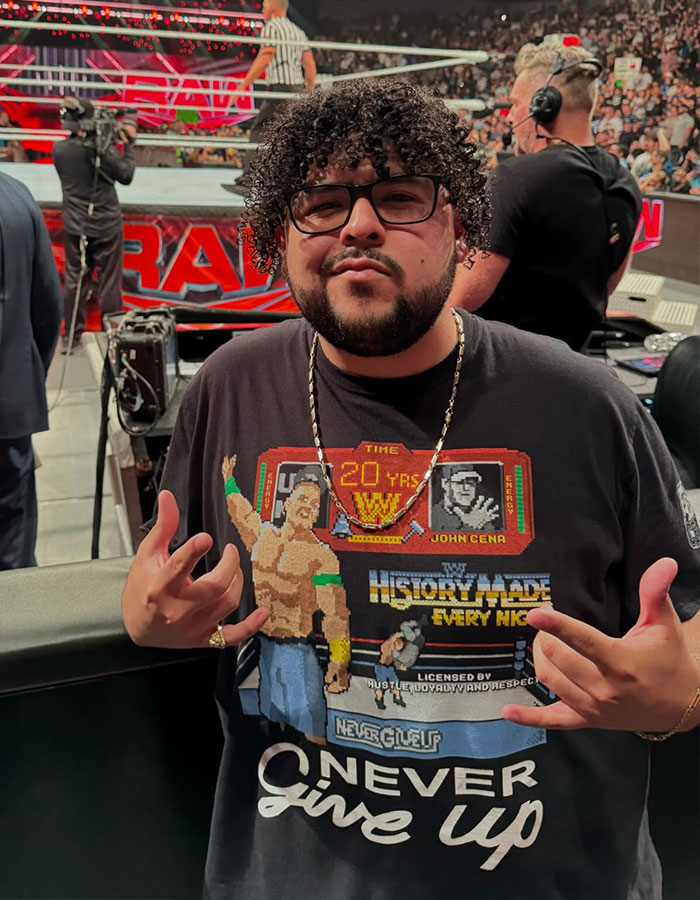 Modern Family star posing on red carpet, wearing glasses and a John Cena t-shirt, surprising fans with new look.