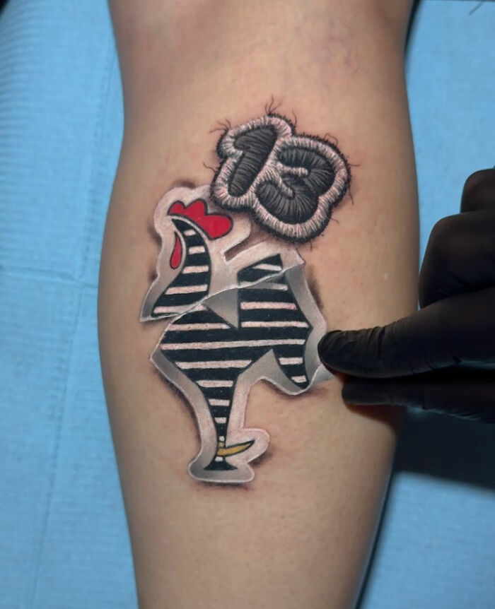 Realistic embroidery tattoo featuring a striped design and the number 13 on skin, showcasing tattoo artistry.