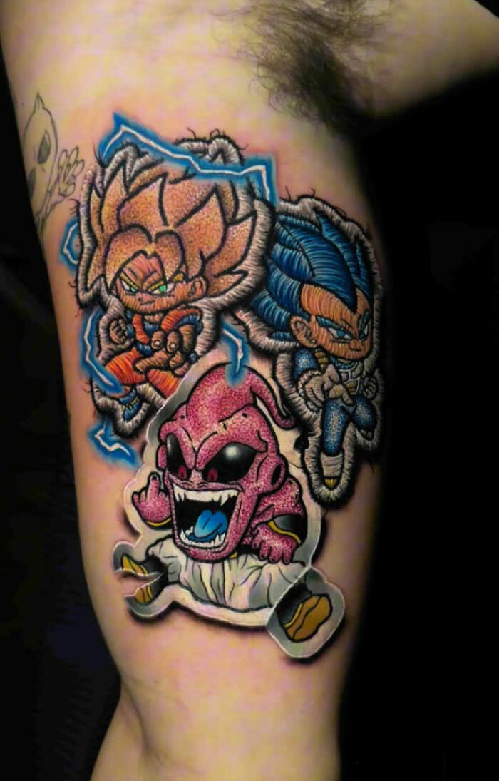 Realistic embroidery tattoo of animated characters with textured appearance on arm.