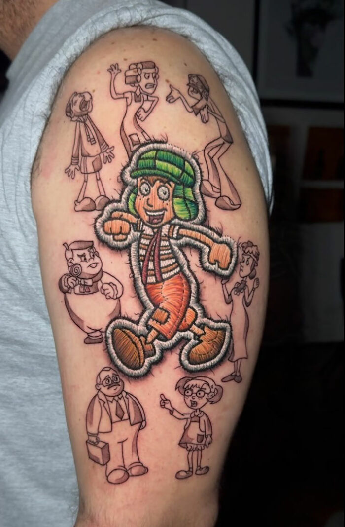 Realistic embroidery tattoo featuring cartoon characters on an arm, showcasing a unique tattoo style.