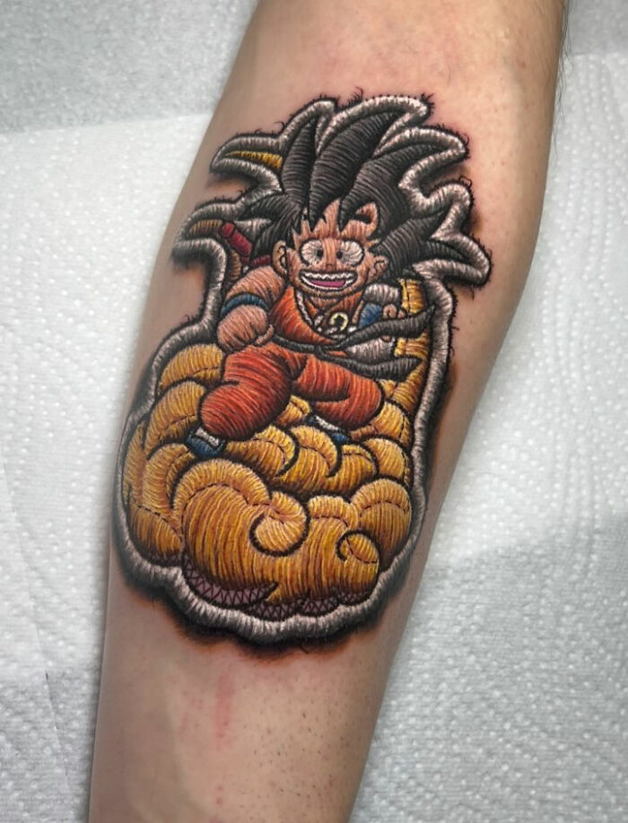 Realistic-looking embroidery tattoo of an anime character on an arm, showcasing vibrant colors and intricate details.