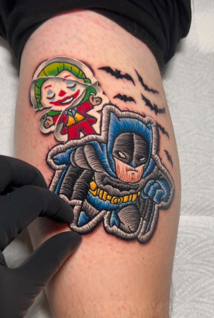 Realistic embroidery tattoo of cartoon characters on forearm, showcasing intricate artwork by a skilled tattoo artist.