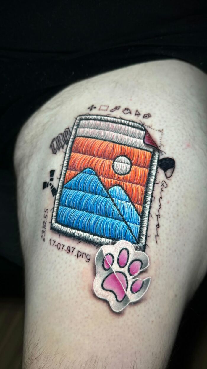 Realistic embroidery tattoo of a landscape with a digital folder design and a pink paw print.