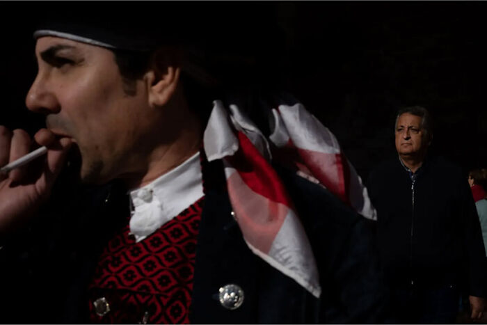 Abstract street photograph by Andrea Pozzoni showing a man with a cigarette and another man in the background.
