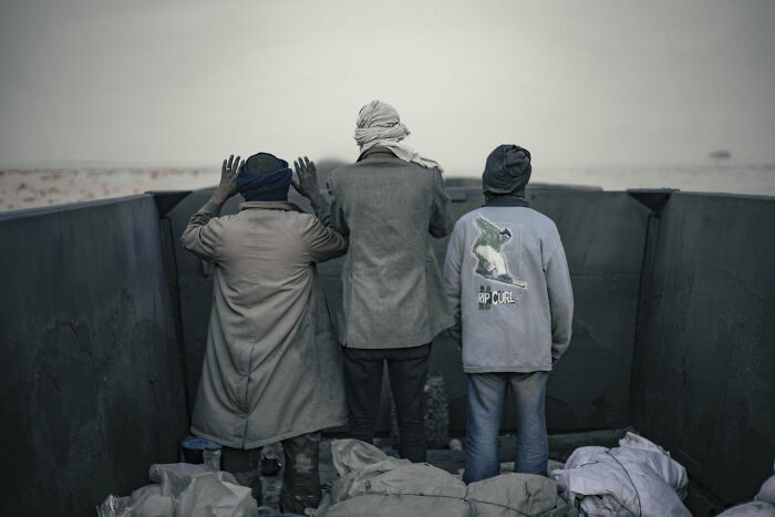 Men Pray At Dusk, Facing Towards Mecca As The Iron Ore Train Rides Through The Desert