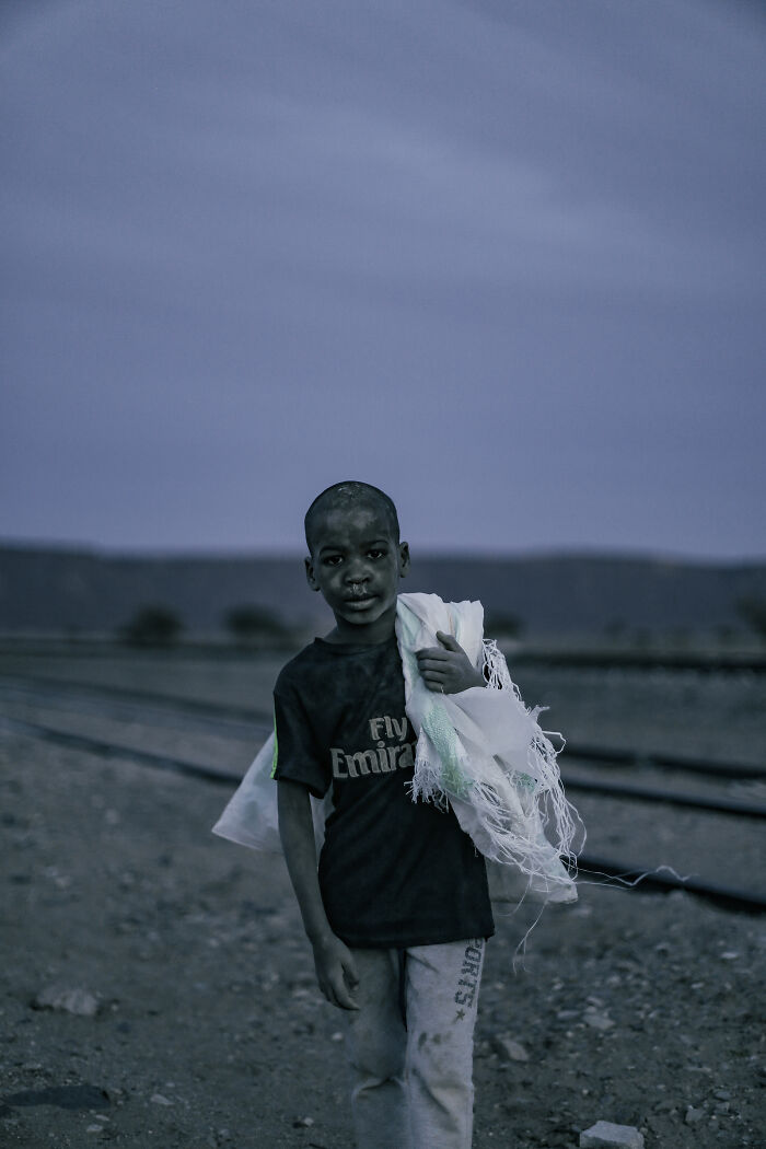 Boy Carries A Bag With Some Bread That He Is Hoping To Sell For The Train Passengers When The Train Arrives