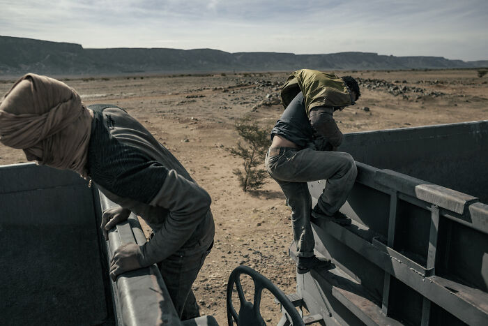 Mauritanian Youngsters Climb Between The Carriages Of The Iron Ore Train As It Approaches The Mines Of Zouerat