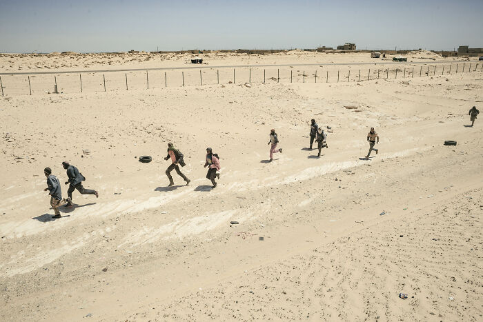 Workers Run To Greet The Arriving Train And Help Their Colleagues Unload The Goods And Livestock From The Train