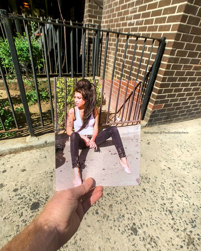 Photo held up at an iconic location, showcasing the spot where a legendary moment was captured.