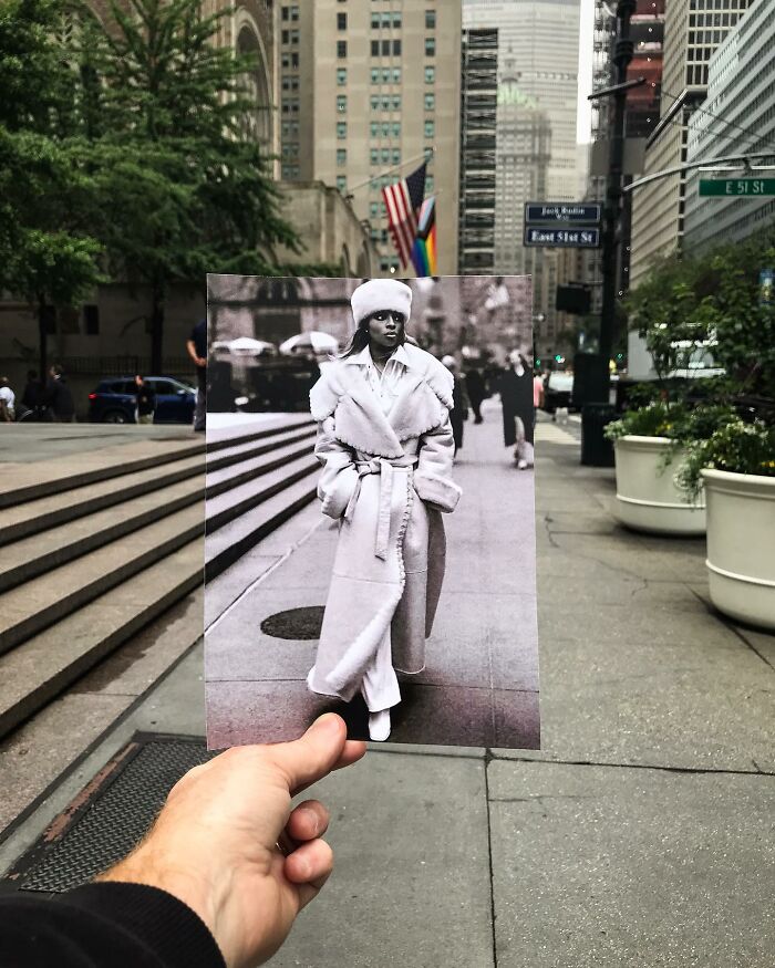 A hand holds a vintage photo of an iconic location, fitting seamlessly with modern surroundings.