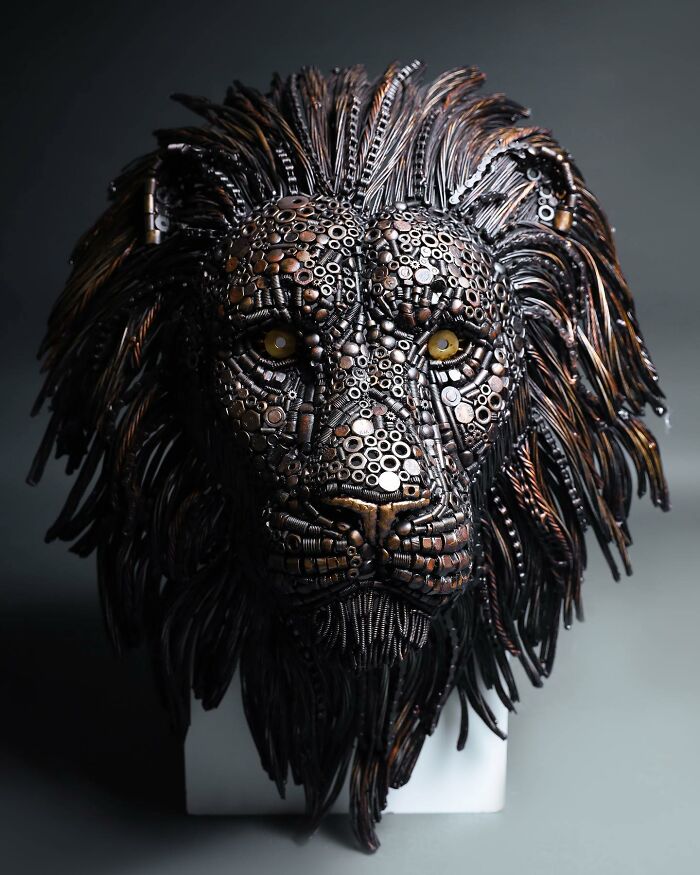 Lion sculpture made from scrap metal, highlighting intricate details and craftsmanship.
