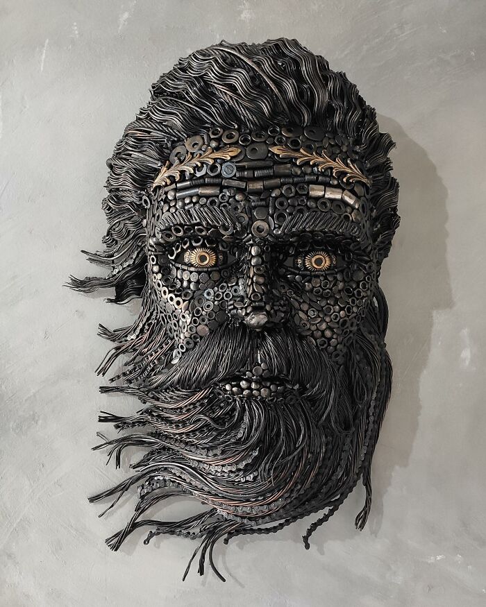 Sculpture of a bearded face made from scrap metal.