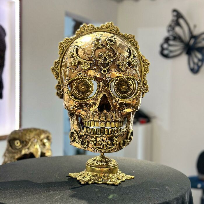 Intricate skull sculpture made from scrap metal, showcasing detailed craftsmanship and artistry.