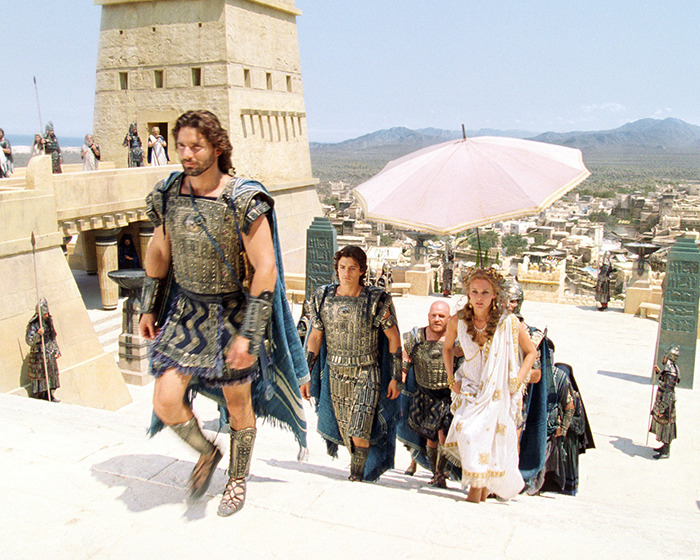 Actors in historical armor on ancient city set, depicting Hollywood's historical inaccuracies.
