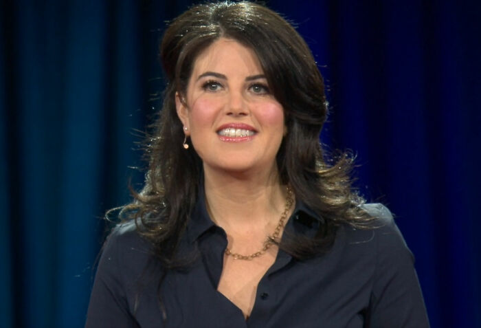 A woman in a dark shirt speaking on stage, highlighting a surprising celebrity insight.