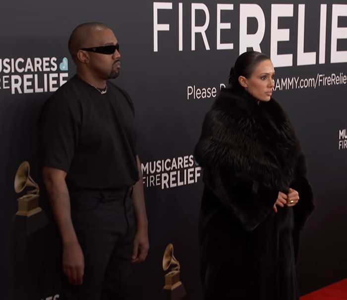 Kanye West in sunglasses and Bianca Censori in fur at the Grammys red carpet. Kanye West in sunglasses and Bianca Censori in fur at the Grammys red carpet.
