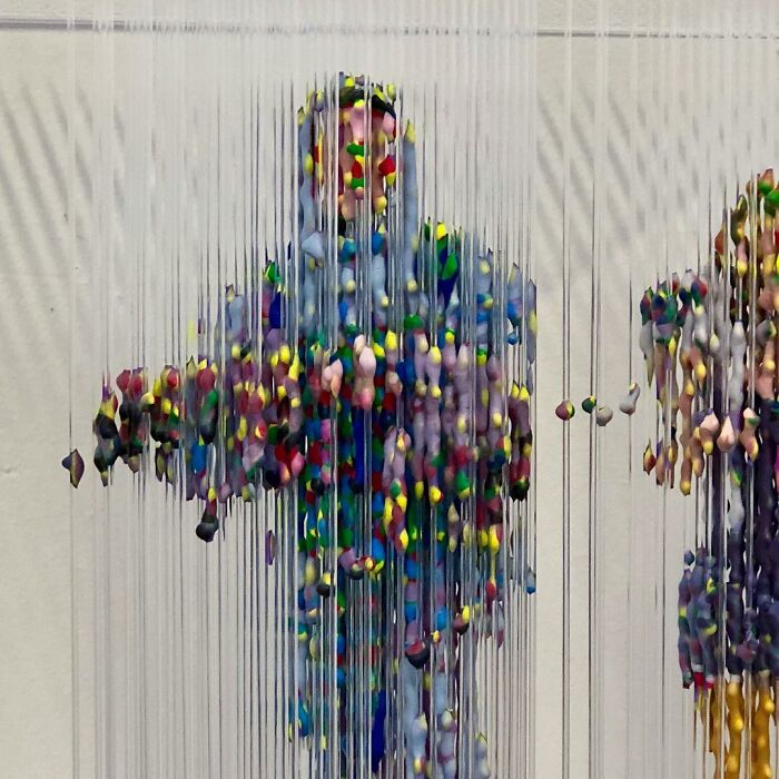 Three-dimensional painting of a person by Chris Dorosz, featuring colorful suspended fragments.