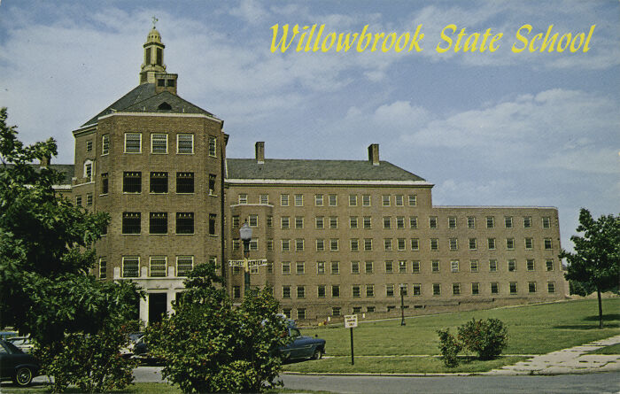 Historic building of Willowbrook State School, related to weird government projects, under a blue sky.