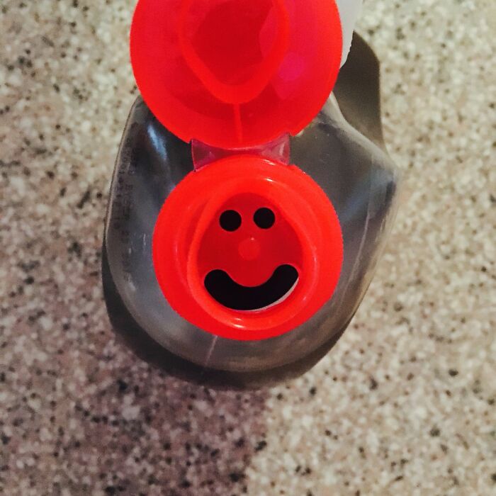 Smiley face on a red bottle cap, showcasing beautifully designed durable packaging.