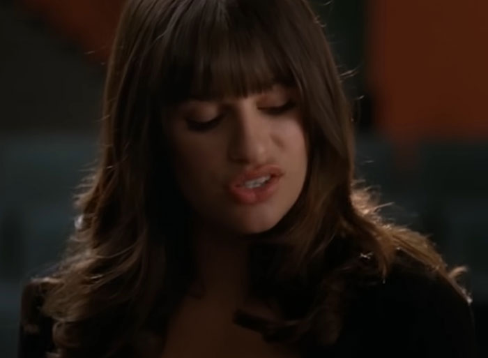 Actor with long hair and bangs, eyes closed, known for being a nightmare to work with, in a dramatic scene.