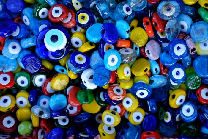 Colorful eye-shaped beads, symbols for protection, reflect cultural traditions.