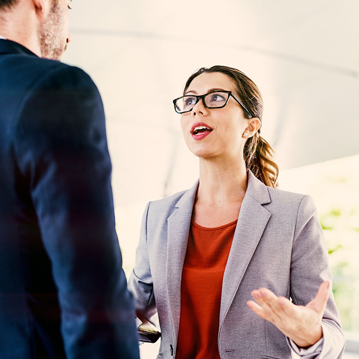 Manager in a conversation with a man, discussing Girl Scout cookies. Manager in a conversation with a man, discussing Girl Scout cookies.