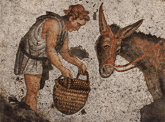 Mosaic artifact depicting an ancient civilization scene with a man and a donkey.
