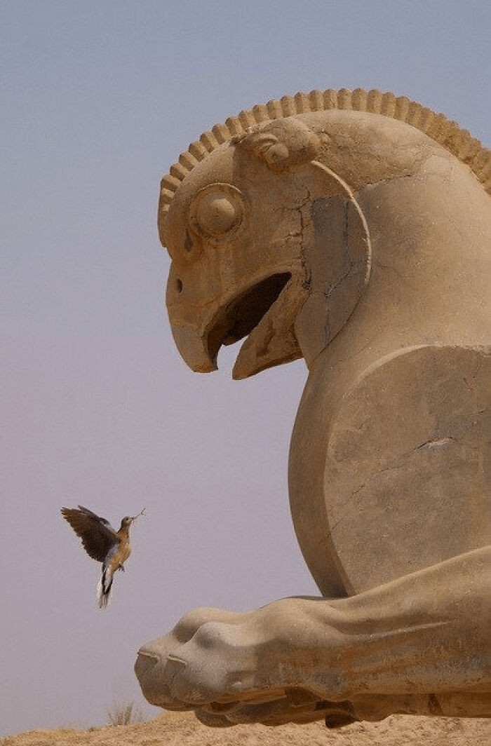 Ancient artifact sculpture resembling a mythical creature with a bird nearby, showcasing ancient civilizations.