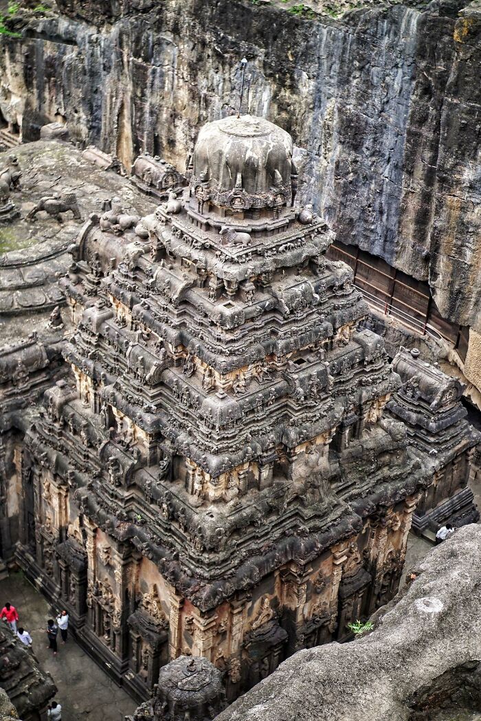 Ancient civilizations: Intricate stone temple structure with detailed carvings, set against a rocky backdrop.