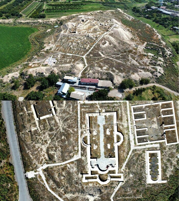 Aerial view of ancient civilization ruins with outlined structures on a hilltop.