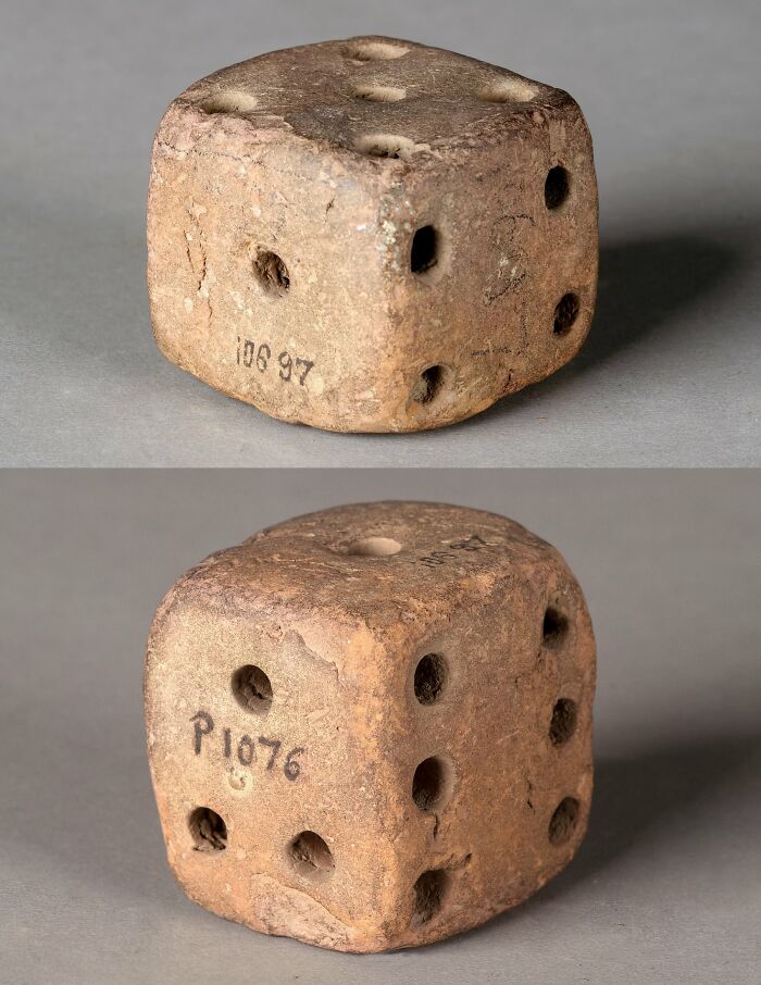Ancient dice artifact with numbered holes, offering a glimpse into ancient civilizations' gaming practices.