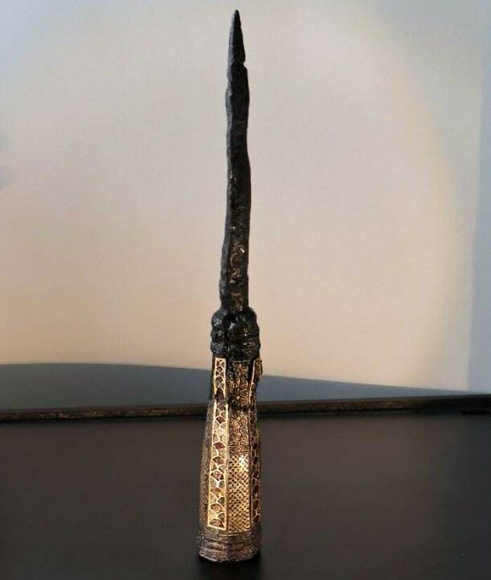 Ancient artifact with intricate designs on a decorated handle, offering a glimpse into ancient civilizations.