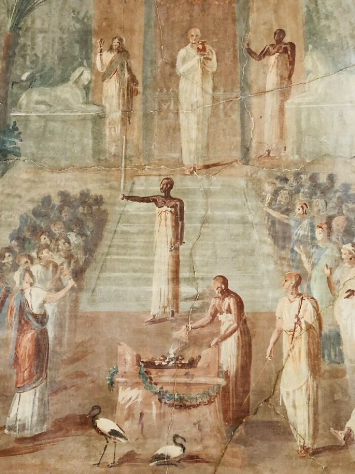 Ancient civilization artifacts depicted in a fresco with figures in togas and ritualistic scenes.