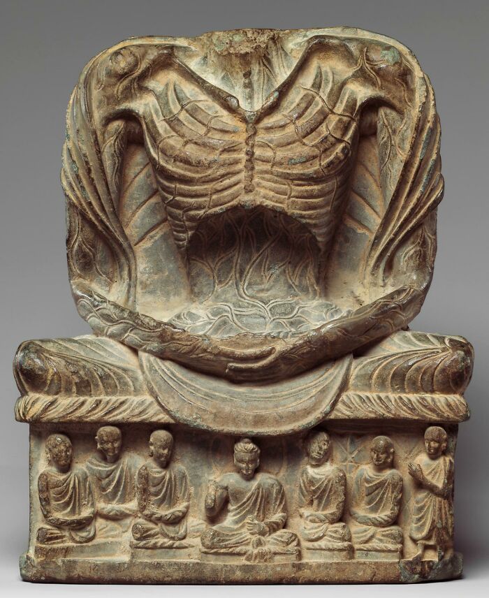 Ancient artifact depicting meditative figure and six seated disciples, highlighting ancient civilizations.