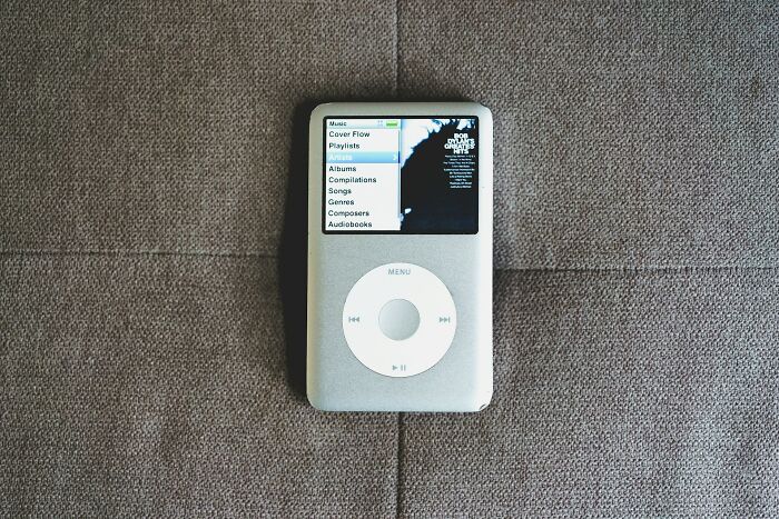 Classic iPod on a gray surface, highlighting music choices, reflecting nostalgia for songs as ringtones.