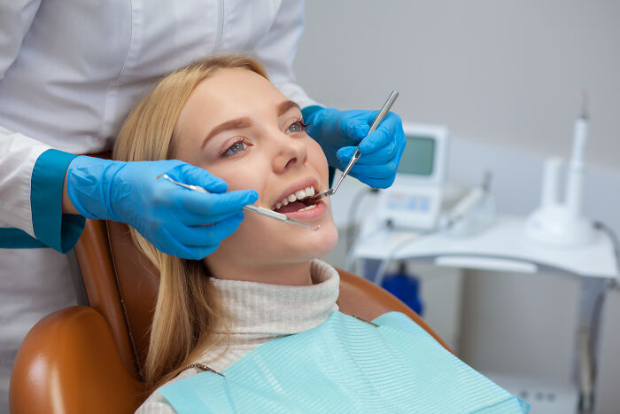 Dentist examining patient's teeth, highlighting common hygiene habits related to stinky breath prevention.