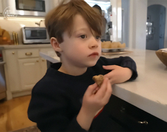 Boy in kitchen holding food, illustrating breakthrough in autism treatment for nonverbal children.