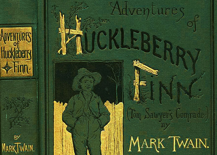 "Cover of 'Adventures of Huckleberry Finn' by Mark Twain, featuring illustration of a boy in a hat and overalls."