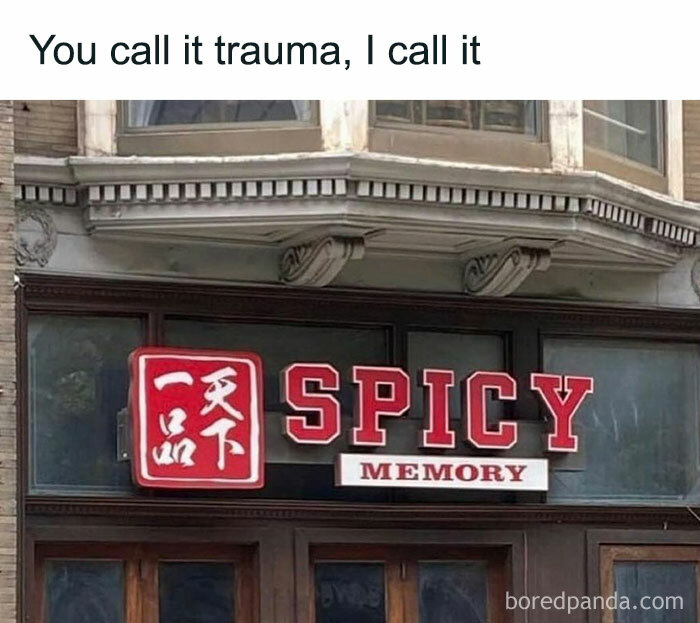 Sign on a building reads "Spicy Memory" with text above saying "You call it trauma, I call it," relating to memes.