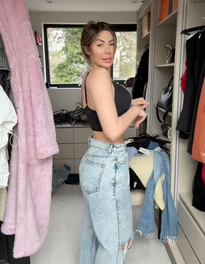 Woman showing new figure after BBL removal in a casual setting, highlighting transformation and recovery journey.