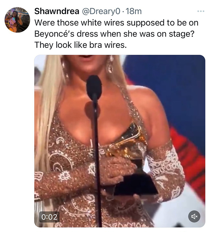 Beyonc&eacute; on stage at the Grammys with gold dress and visible white wires, addressing wardrobe malfunction concerns.
