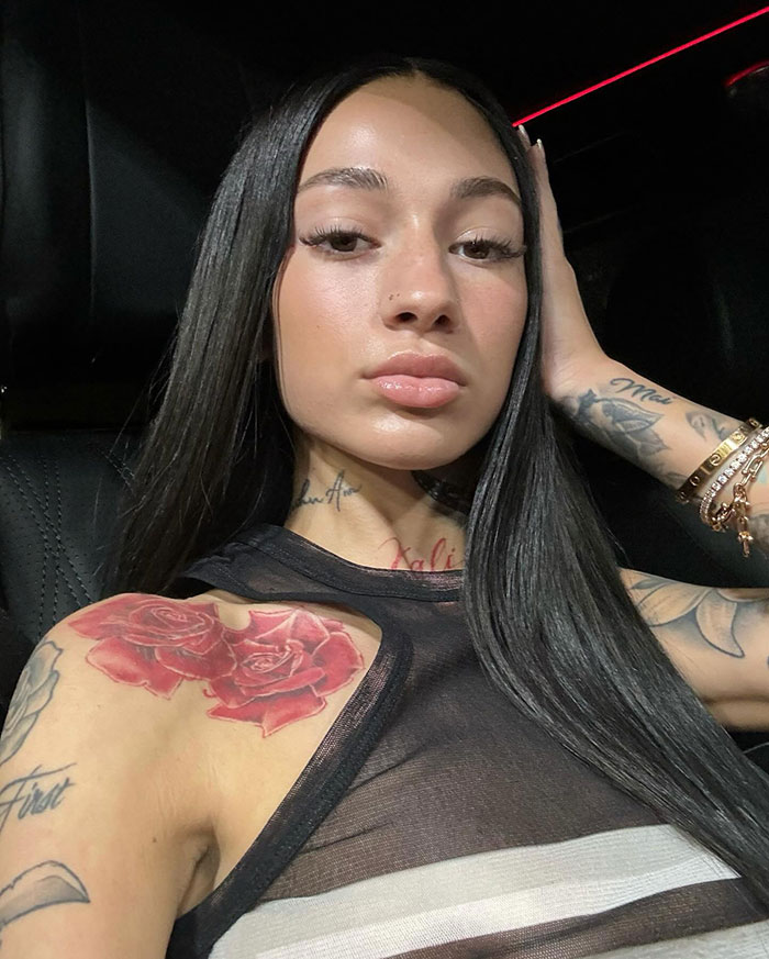 Person with black hair and tattoos posing in a car, associated with "47-Year-Old Mob Wife" style discussion. Person with black hair and tattoos posing in a car, associated with "47-Year-Old Mob Wife" style discussion.
