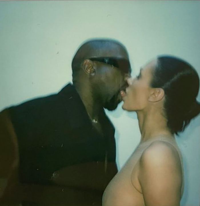 A couple sharing an intimate moment, with a focus on orchestrating their public image amidst personal rumors.