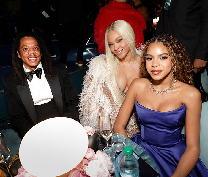 Family at an event, with a young girl in a blue dress, related to an inappropriate Grammys dress controversy. Family at an event, with a young girl in a blue dress, related to an inappropriate Grammys dress controversy.