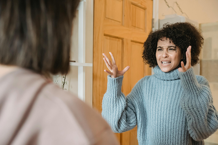 Woman gesturing angrily in a room, discussing the MIL's wedding dress. Woman gesturing angrily in a room, discussing the MIL's wedding dress.