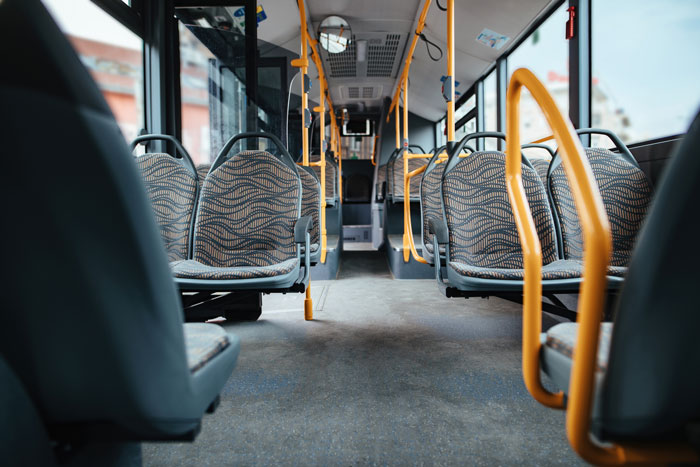Empty bus interior with multiple vacant seats, emphasizing space availability. Empty bus interior with multiple vacant seats, emphasizing space availability.