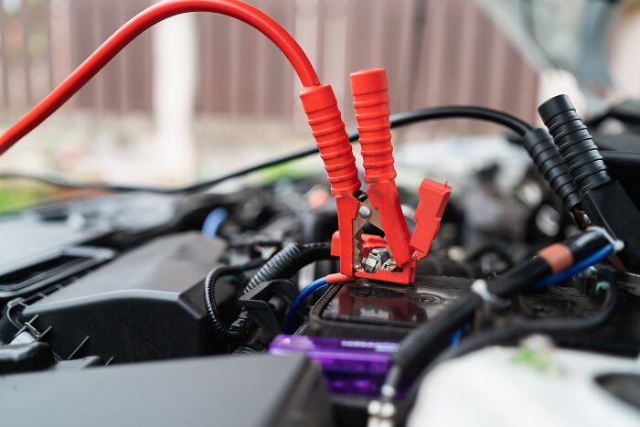 Car battery with jumper cables attached, a practical gift idea for someone who has everything.