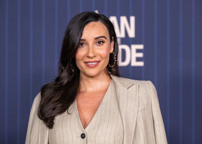 Actress Lilah Richcreek at "A Man On The Inside" event in a beige blazer, part of the cast alongside Ted Danson.